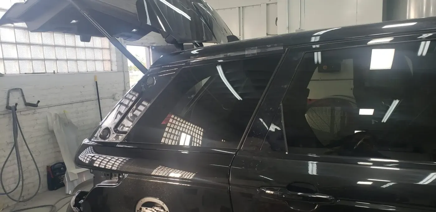 Auto glass replacement on a black SUV