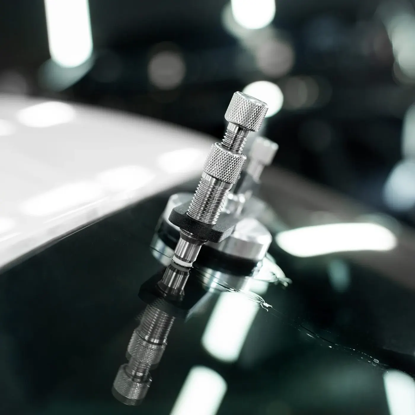 Professional windshield chip repair tool injecting resin into a chip