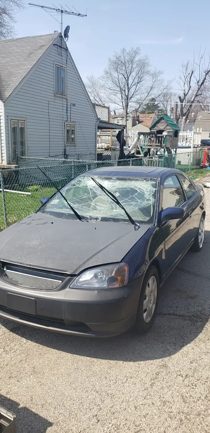 Before — minivan with shattered windshield