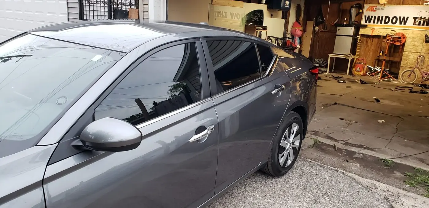 Technician performing auto glass replacement inside the Mr. Glass Chicago shop