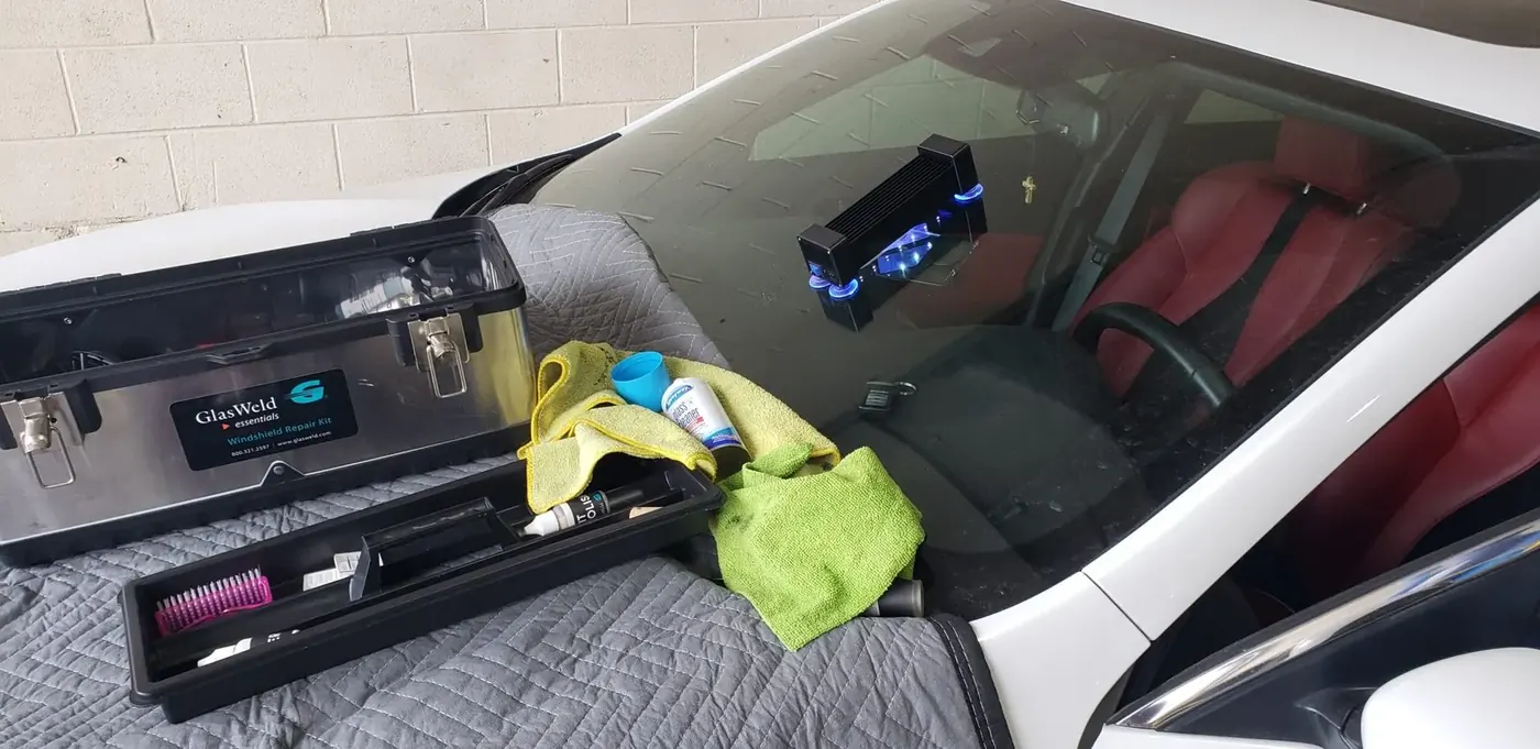 Mr. Glass Chicago technician performing mobile windshield service on a white vehicle
